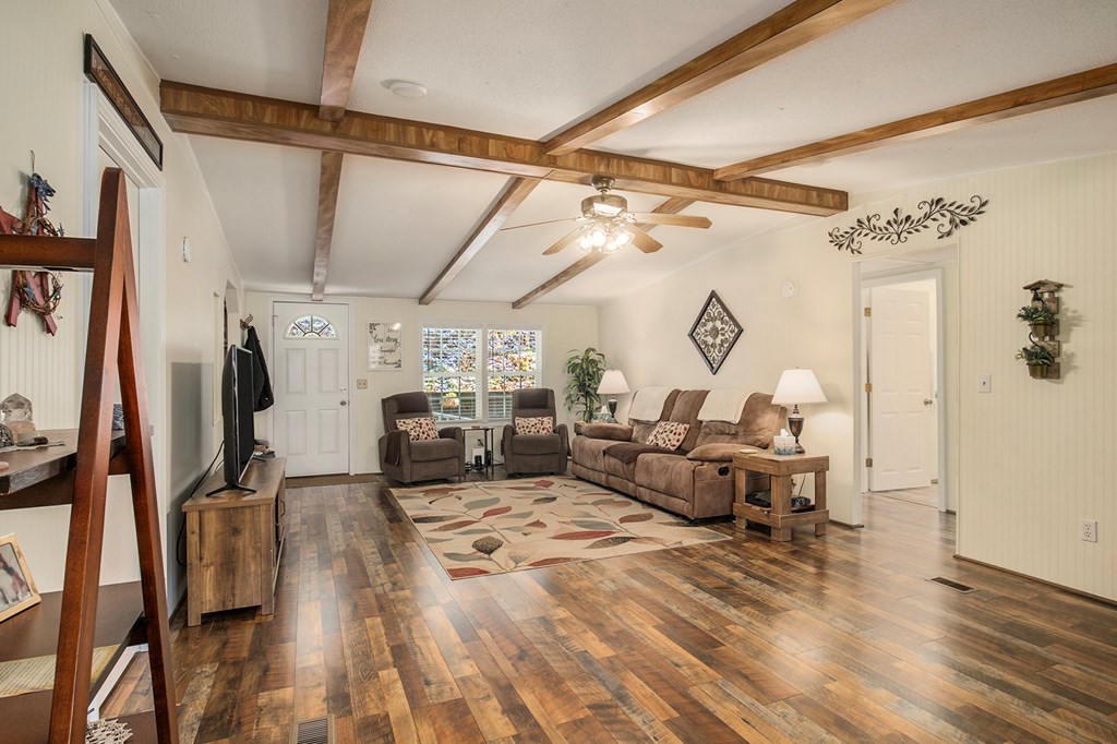 2226 Layson Road Hiawassee, GA 30546 - Photo 4 of 38 a living room with lots of furniture and a chandelier