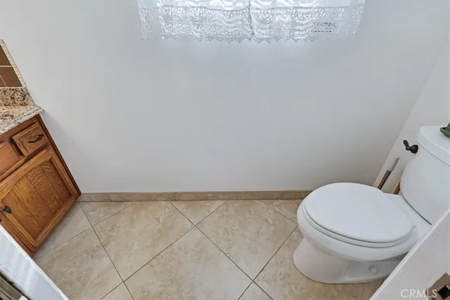 a view of bathroom with a toilet sink and mirror