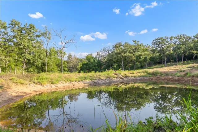 a view of a lake with houses in the back