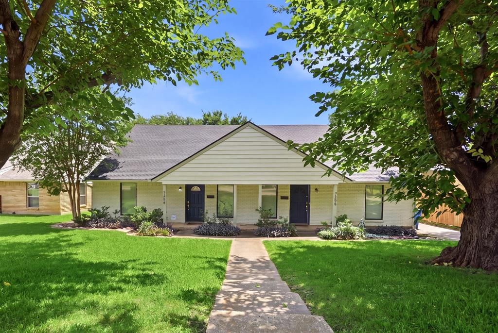 7354 Walling Lane Dallas, TX 75231 - Photo 2 of 28 a front view of a house with a yard and garden