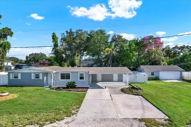 a view of a house with backyard sitting area and garden