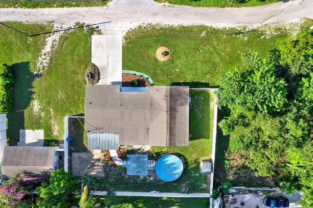 an aerial view of a house with yard swimming pool and outdoor seating