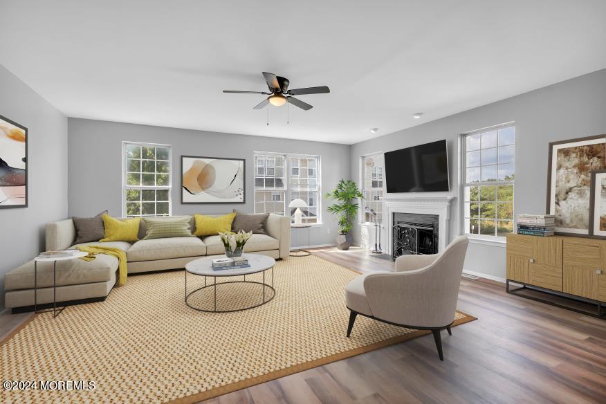 a living room with furniture a fireplace and a flat screen tv