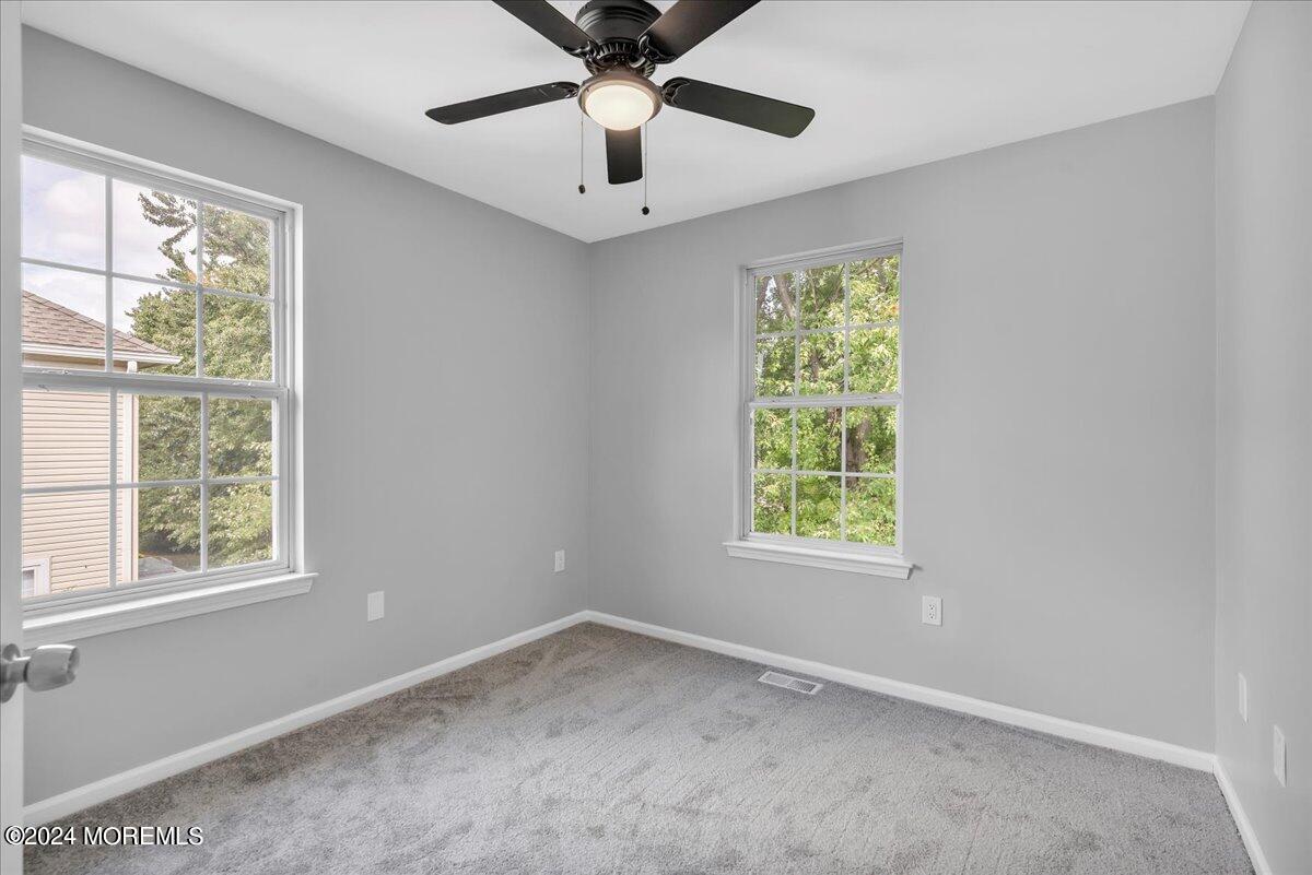 7701 Juniper Lane Palmyra, NJ 08065 - Photo 13 of 31 an empty room with a window and a fan