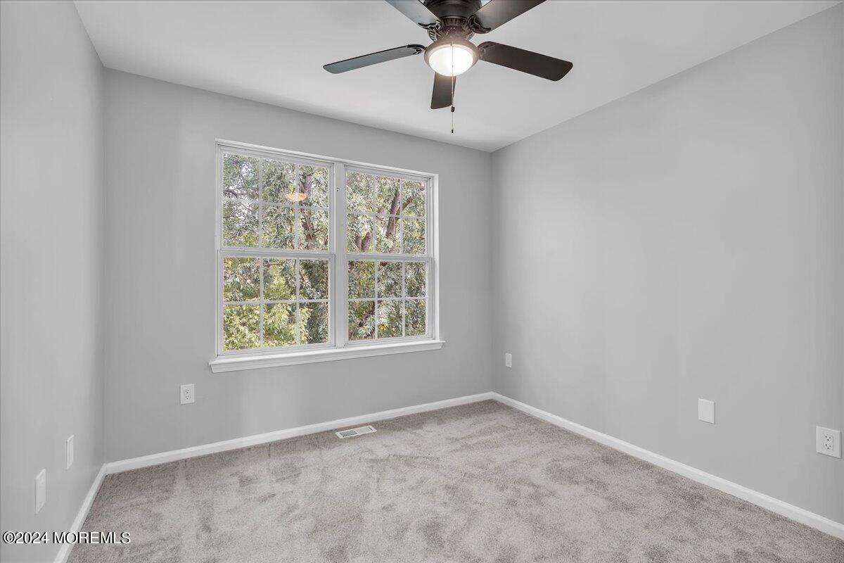 7701 Juniper Lane Palmyra, NJ 08065 - Photo 15 of 31 an empty room with a window and a fan