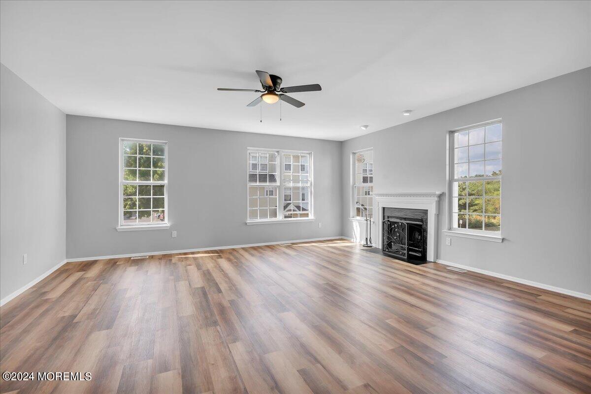 7701 Juniper Lane Palmyra, NJ 08065 - Photo 5 of 31 a view of an empty room with wooden floor fireplace and a window