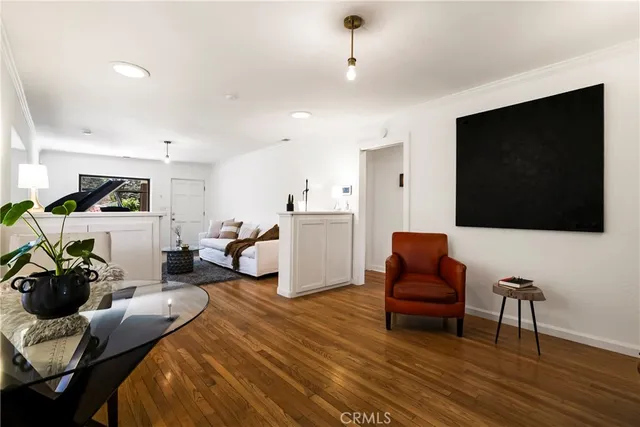 a bedroom with furniture and a flat screen tv