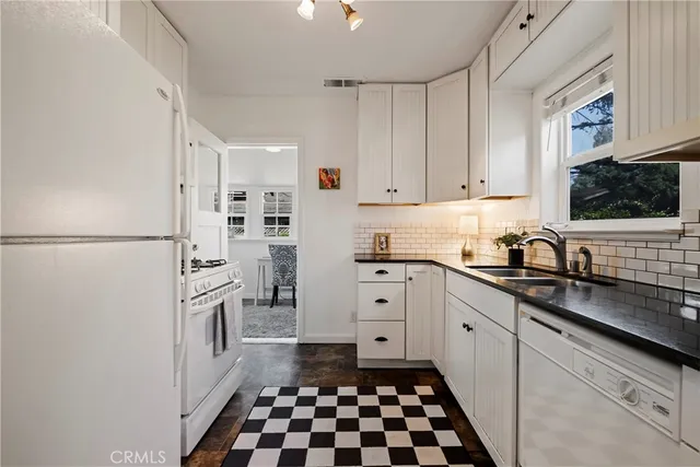 a kitchen with stainless steel appliances a refrigerator sink and cabinets