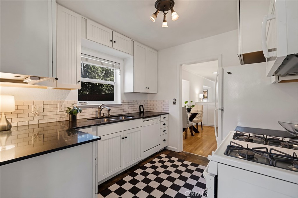 234 West 3rd Avenue Chico, CA 95926 - Photo 16 of 54 a kitchen with granite countertop a sink a stove and refrigerator
