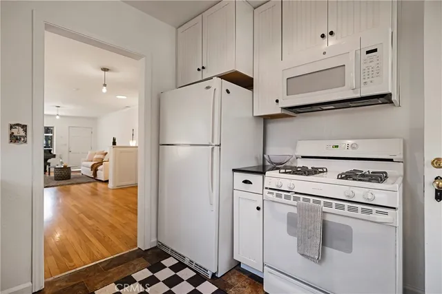 a kitchen with stainless steel appliances granite countertop a refrigerator sink and stove