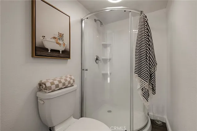 a bathroom with a toilet and a shower