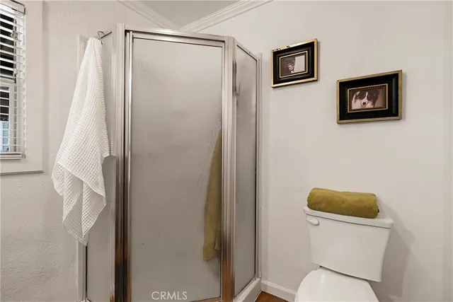 a bathroom with a toilet and a shower