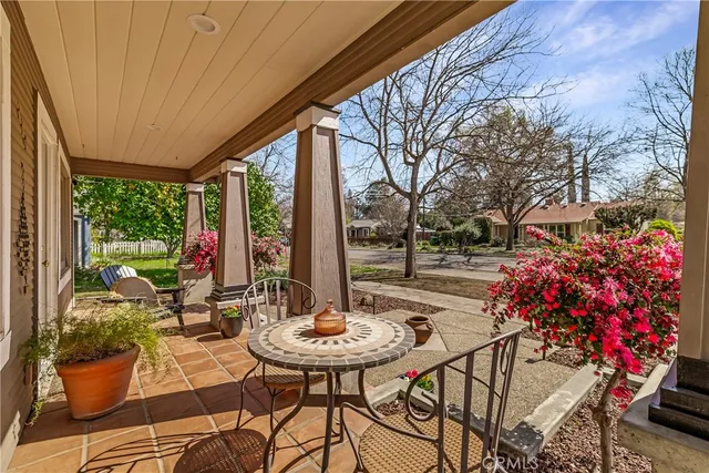 a view of a patio with a table chairs and a potted plant