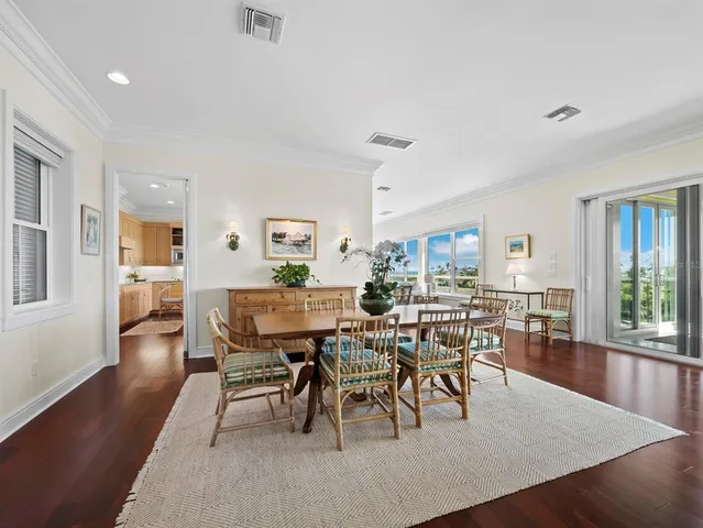 a living room with furniture dining table and wooden floor