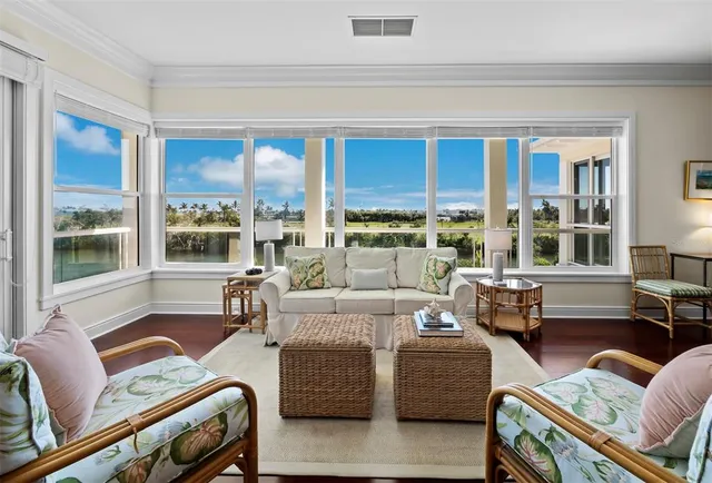 a living room with furniture a wooden floor and a chandelier