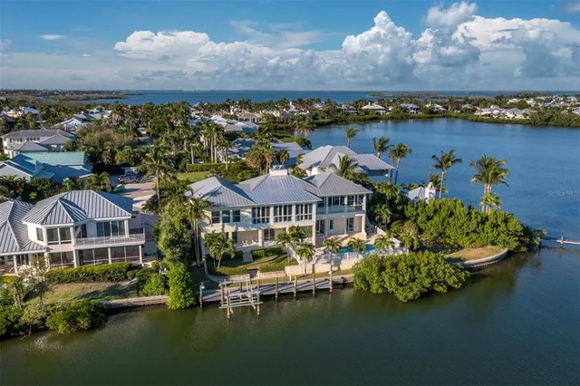 an aerial view of a house with a lake view