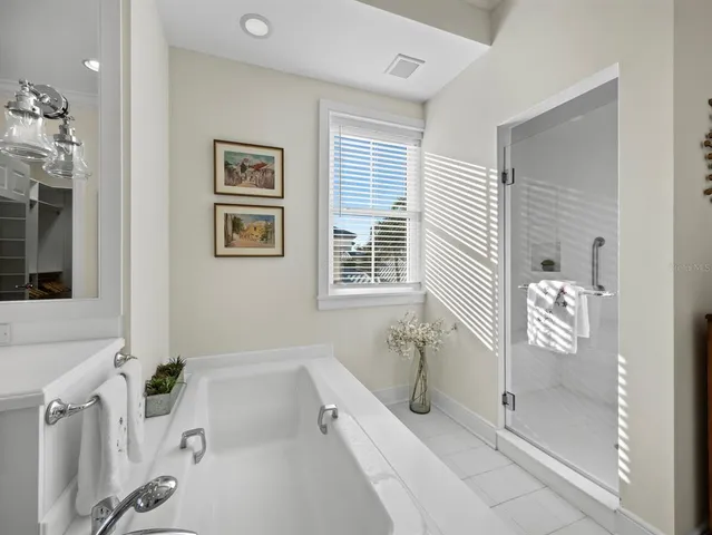 an aerial view of a house with outdoor space and lake view