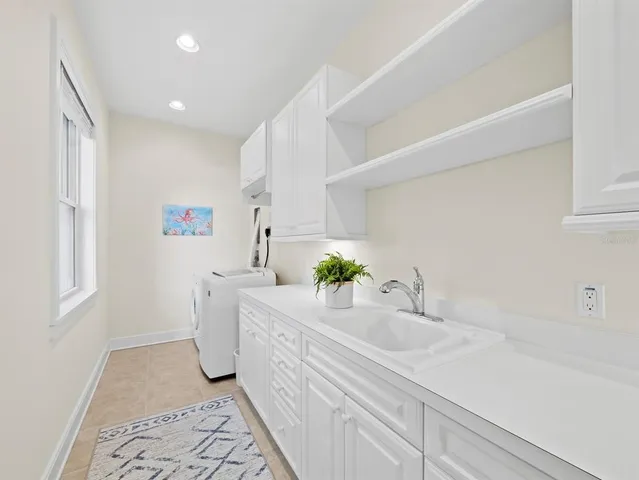 an aerial view of a city with lake view in back