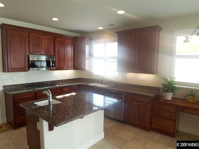 10145 Gold Mine Drive Reno, NV 89521 - Photo 2 of 9 a kitchen with granite countertop a sink a window and stainless steel appliances