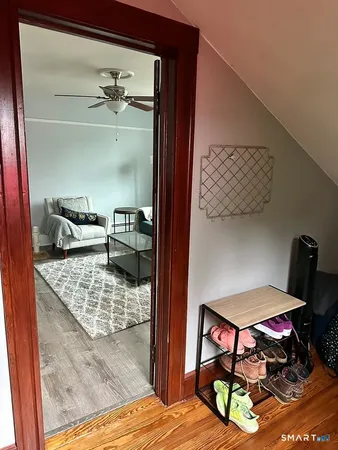 a bedroom with furniture and a wooden floor