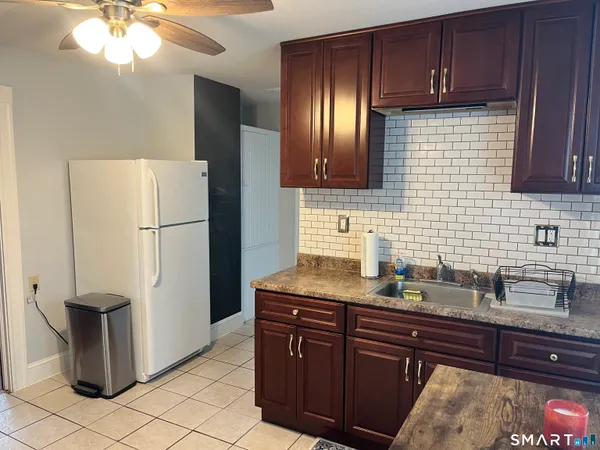 a kitchen with a refrigerator and microwave