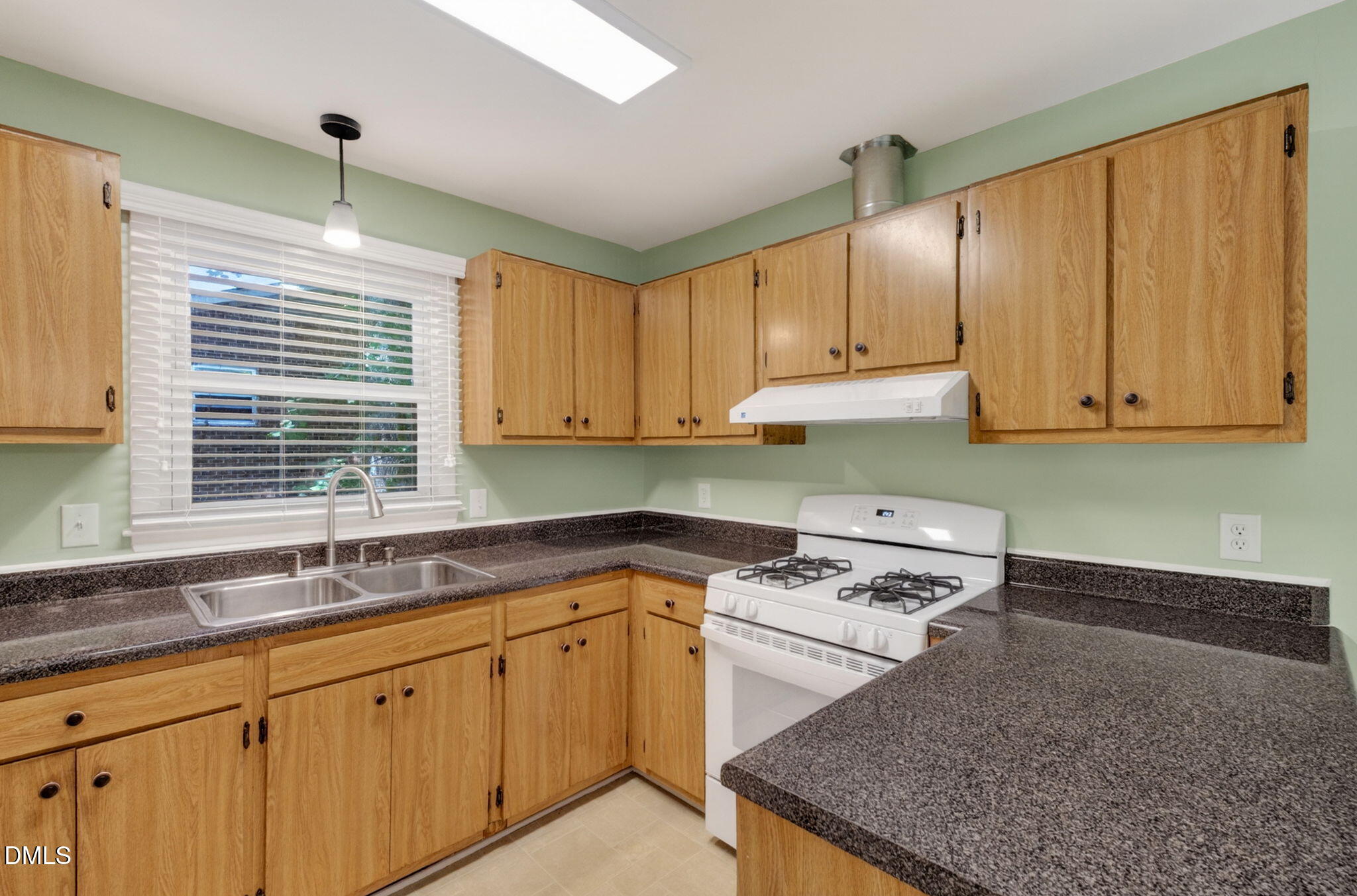 1224 Pineview Drive Raleigh, NC 27606 - Photo 15 of 45 a kitchen with granite countertop a sink stove and cabinets