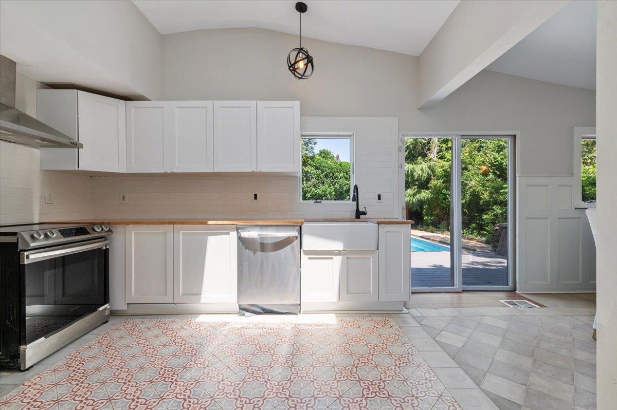 56 West Donellan Road Hampton Bays, NY 11946 - Photo 11 of 27 a view of a kitchen with furniture and stainless steel appliances