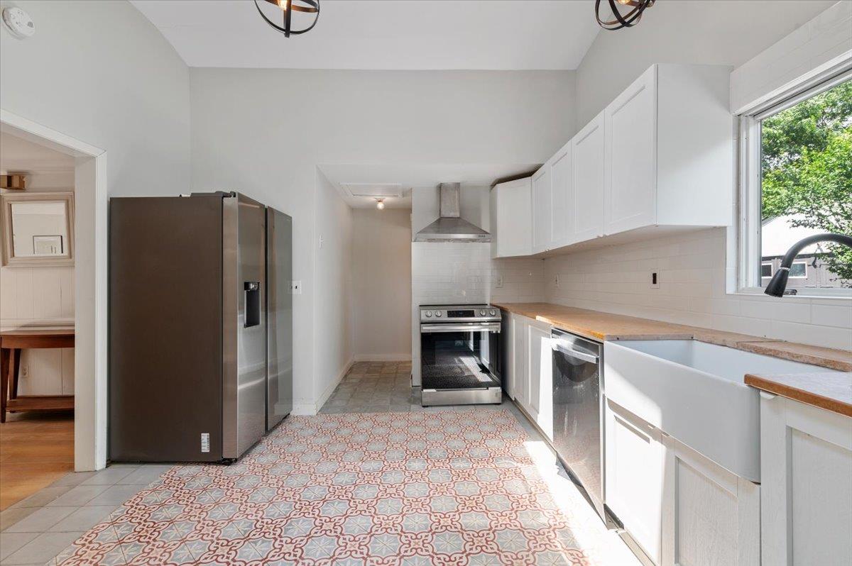 56 West Donellan Road Hampton Bays, NY 11946 - Photo 12 of 27 a kitchen with stainless steel appliances granite countertop a refrigerator and a sink