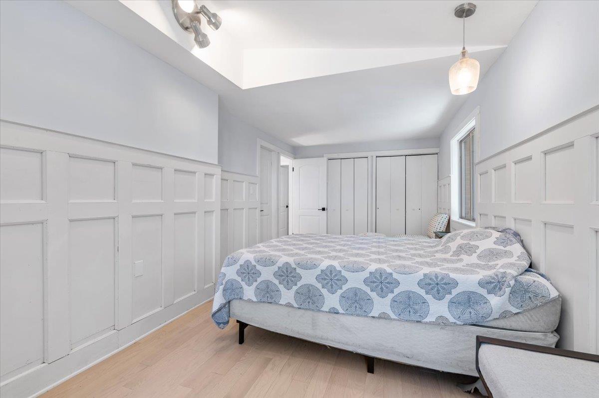 56 West Donellan Road Hampton Bays, NY 11946 - Photo 17 of 27 a bedroom with a bed and a ceiling fan