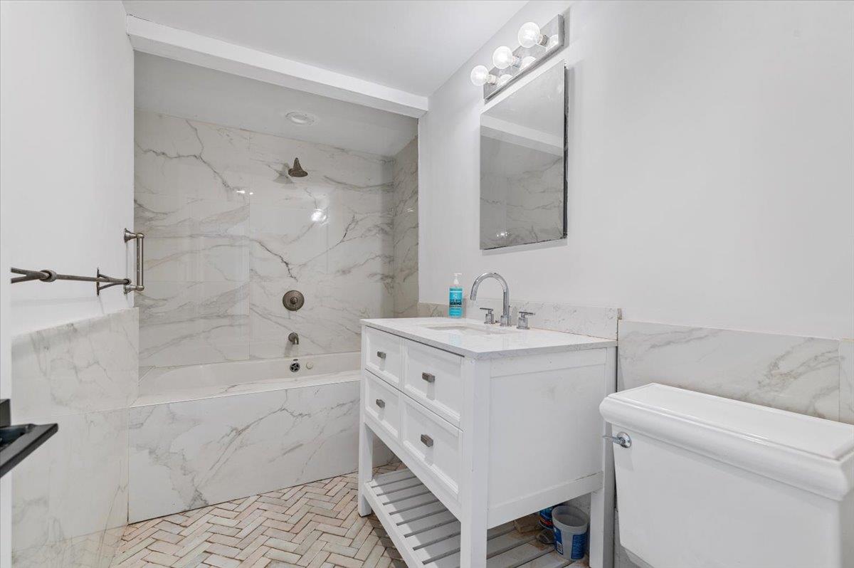 56 West Donellan Road Hampton Bays, NY 11946 - Photo 18 of 27 a bathroom with a sink a toilet and shower