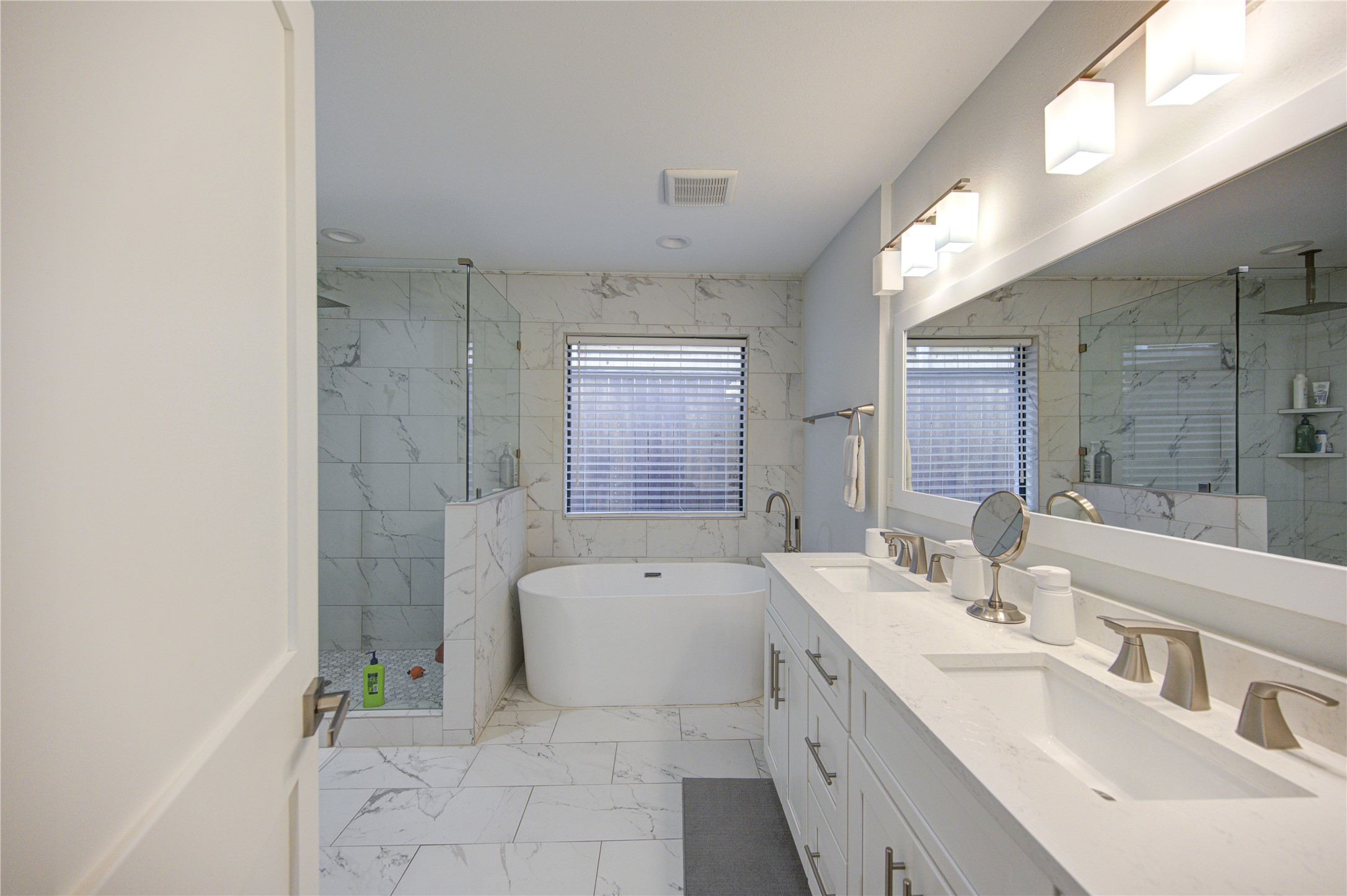 1215 Bethlehem Street Houston, TX 77018 - Photo 16 of 42 a spacious bathroom with a double vanity sink mirror and a bathtub