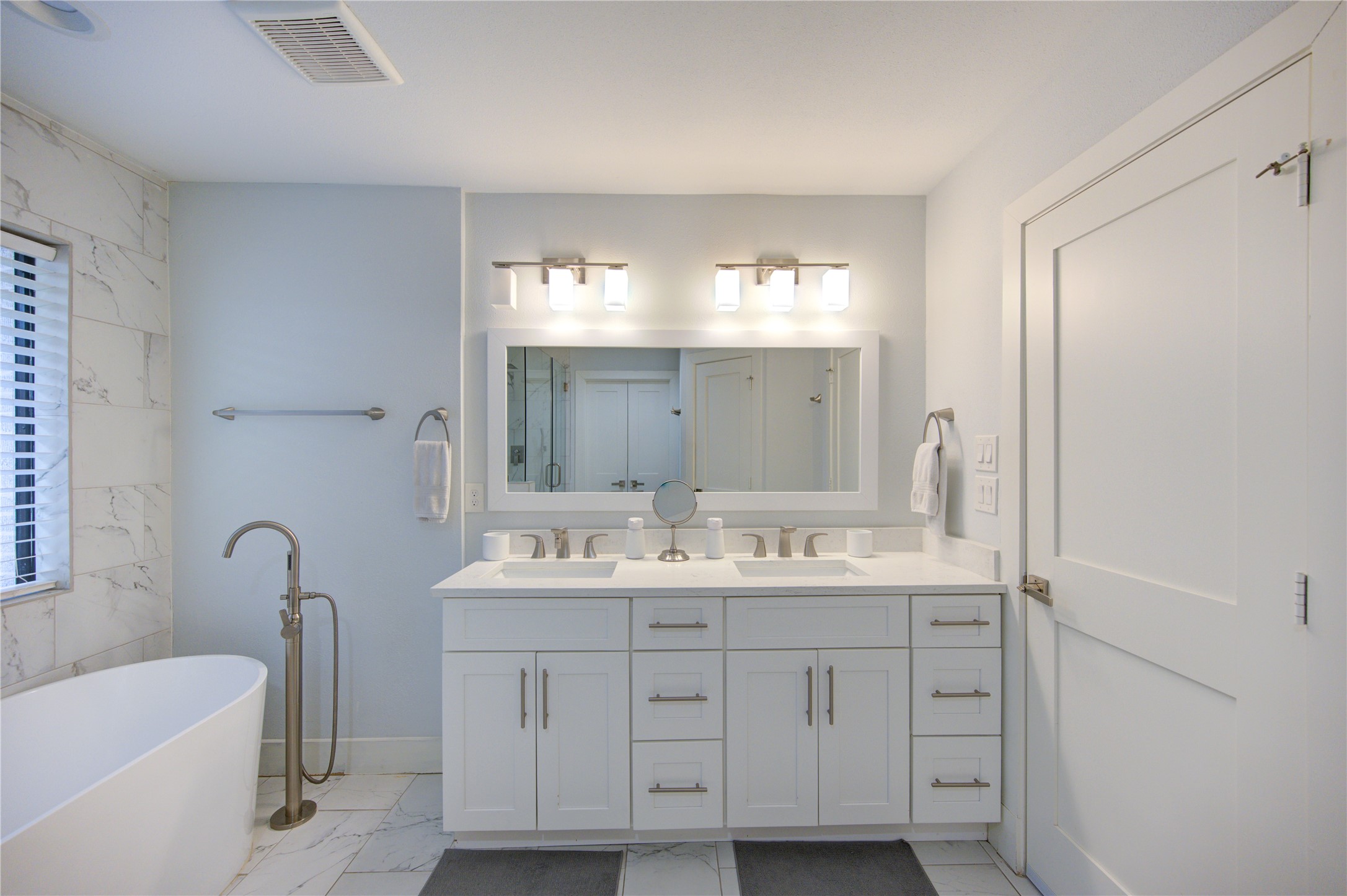 1215 Bethlehem Street Houston, TX 77018 - Photo 17 of 42 a bathroom with a double vanity sink a mirror and a bathtub