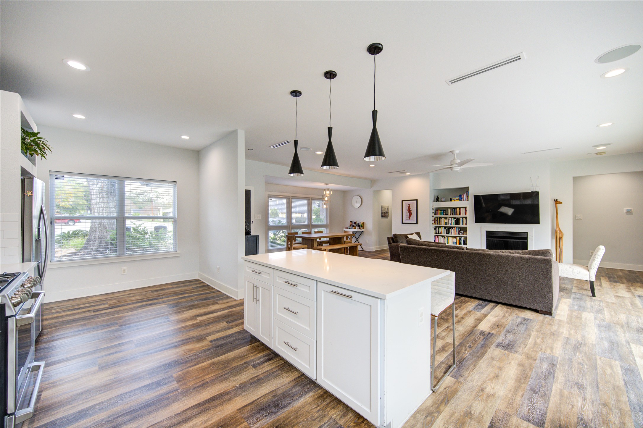1215 Bethlehem Street Houston, TX 77018 - Photo 5 of 42 a large kitchen with stainless steel appliances kitchen island granite countertop a stove a sink a refrigerator and white cabinets with wooden floor