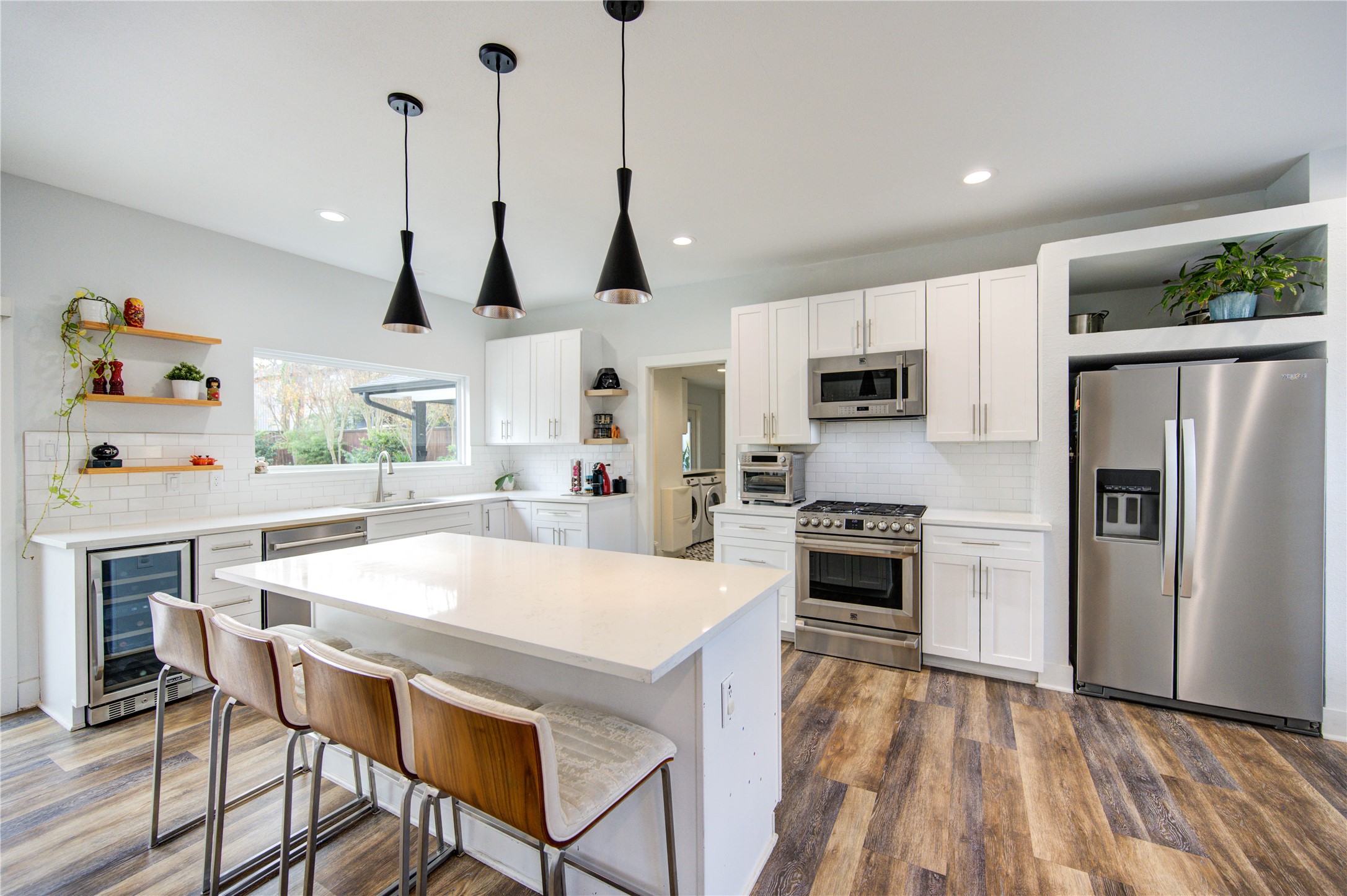 1215 Bethlehem Street Houston, TX 77018 - Photo 7 of 42 a kitchen with stainless steel appliances granite countertop a stove a refrigerator a oven a sink with a dining table and chairs