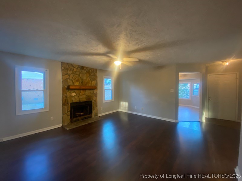 110 Bruce Lane Spring Lake, NC 28390 - Photo 3 of 11 an empty room with wooden floor fireplace and windows