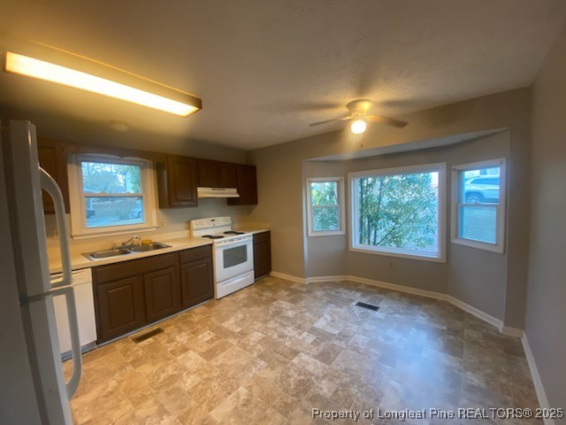 110 Bruce Lane Spring Lake, NC 28390 - Photo 4 of 11 a kitchen with stainless steel appliances granite countertop a stove a sink and a refrigerator