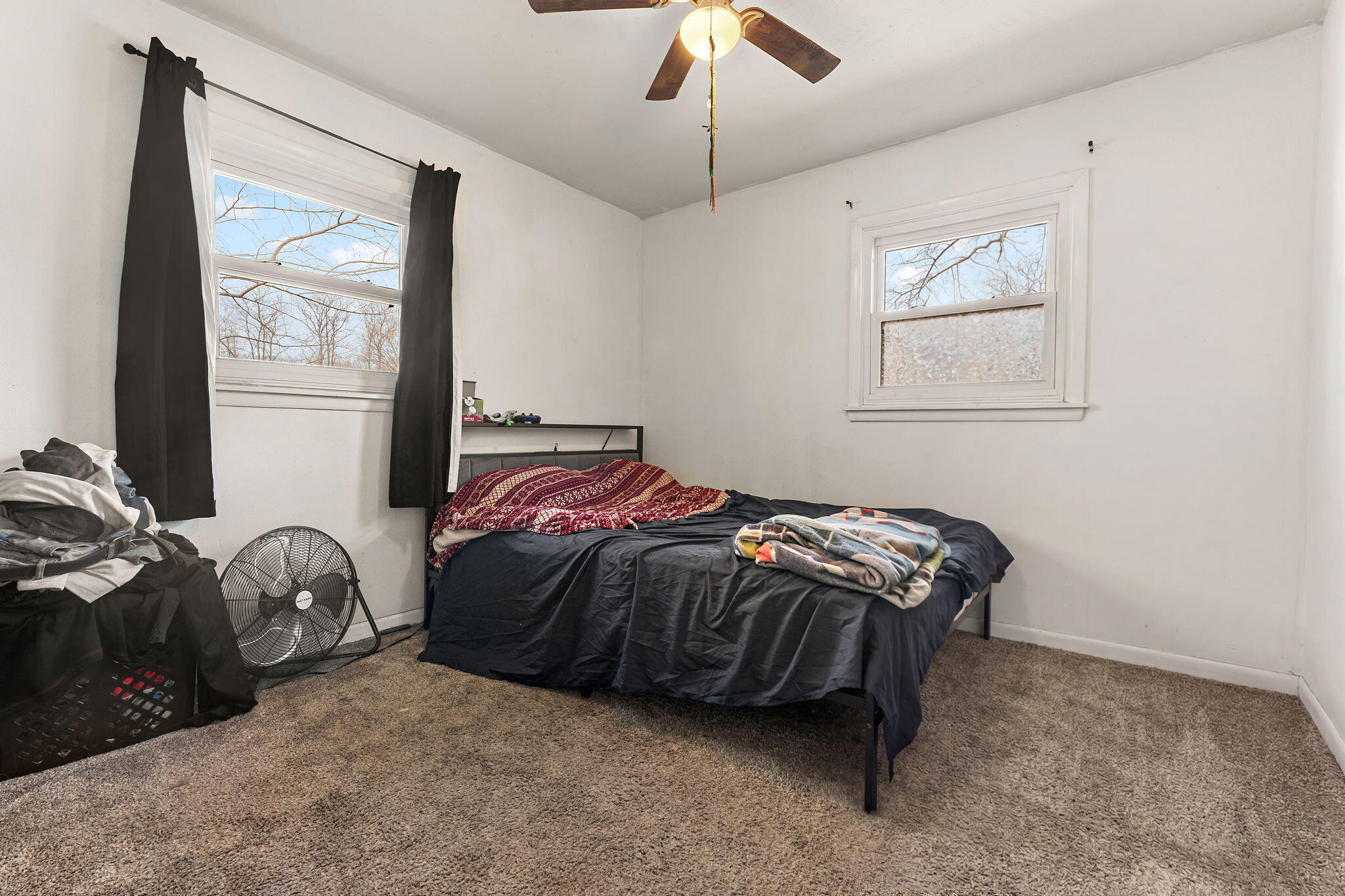 2334 Venus Street Portage, IN 46368 - Photo 11 of 22 a bedroom with a bed and a chandelier