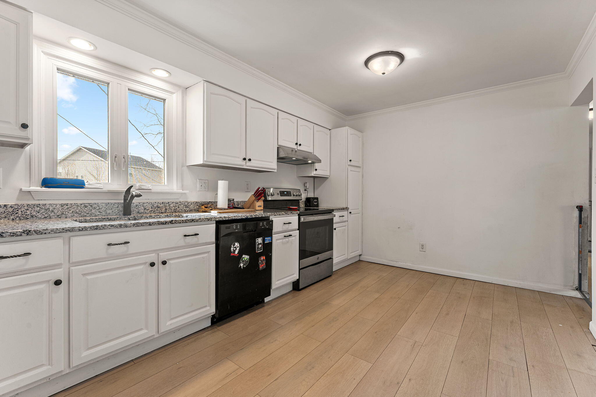 2334 Venus Street Portage, IN 46368 - Photo 6 of 22 a kitchen with granite countertop white cabinets and white appliances