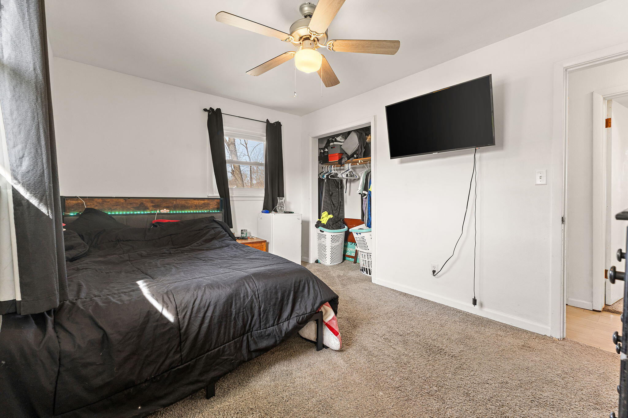 2334 Venus Street Portage, IN 46368 - Photo 9 of 22 a bedroom with a bed a flat screen tv and a chandelier