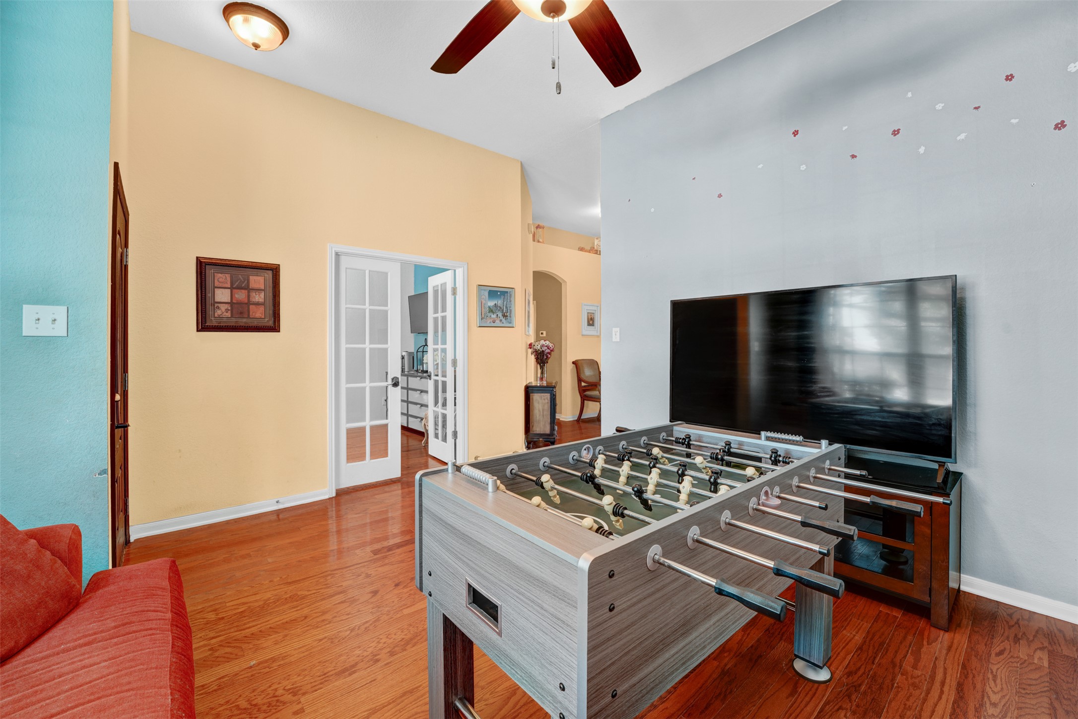 2521 Amen Corner Road Pflugerville, TX 78660 - Photo 17 of 40 Spacious room featuring wood-finish flooring, vaulted ceilings, and a ceiling fan with integrated lighting