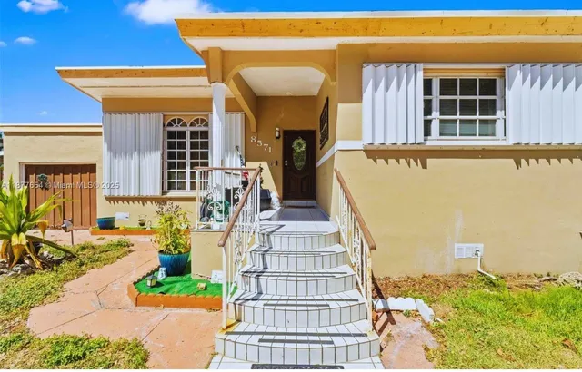 a front view of a house with glass windows and couches