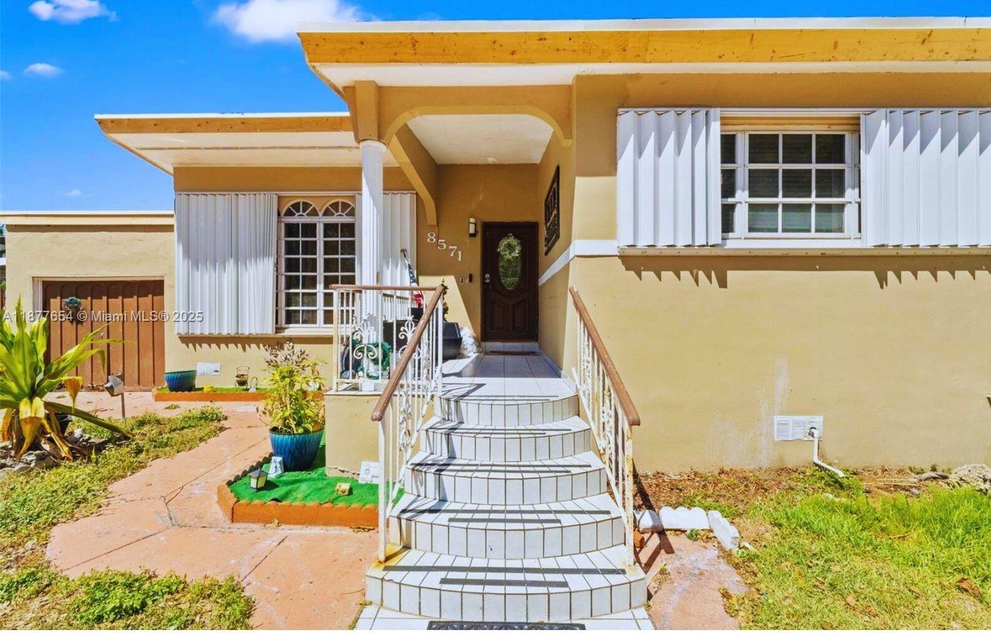 8571 Southwest 30th Street Miami, FL 33155 - Photo 2 of 15 a front view of a house with glass windows and couches