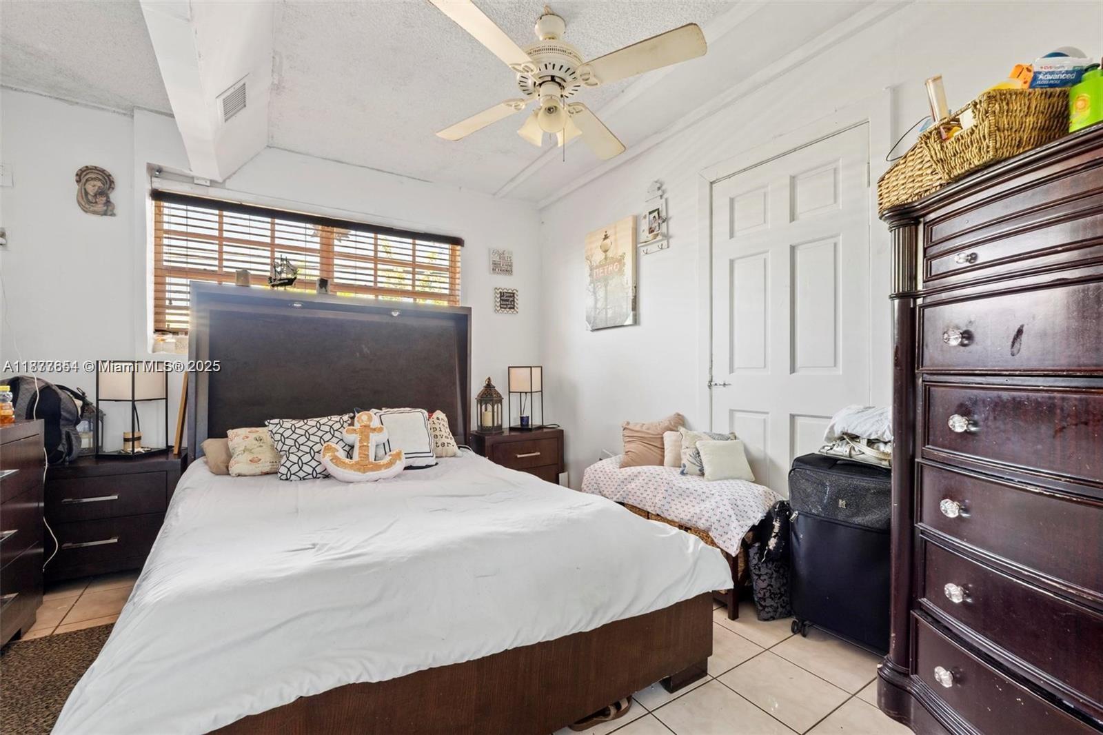 8571 Southwest 30th Street Miami, FL 33155 - Photo 9 of 15 a bedroom with a bed and wooden floor