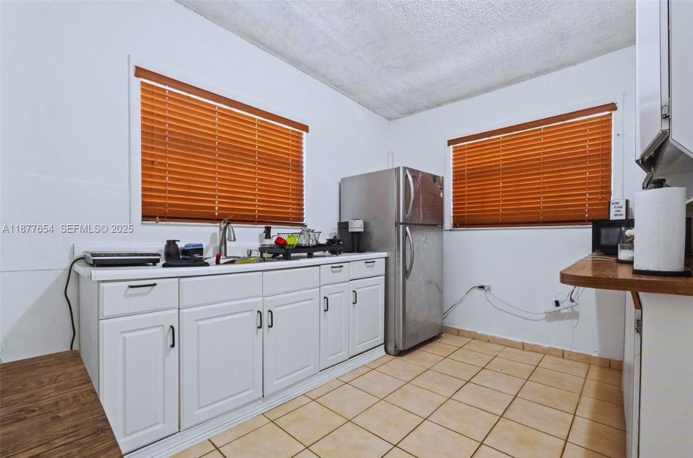 8571 Southwest 30th Street Miami, FL 33155 - Photo 10 of 15 a kitchen with sink cabinets and refrigerator
