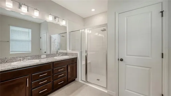 a bathroom with a granite countertop sink mirror and double