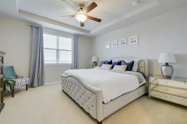 a bedroom with a bed and ceiling fan