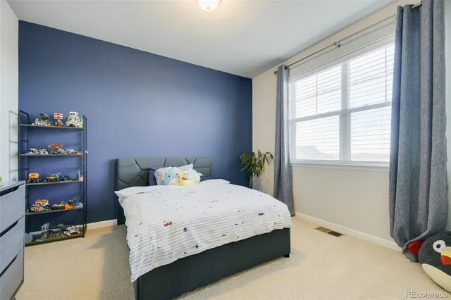 a bedroom with a bed and chandelier