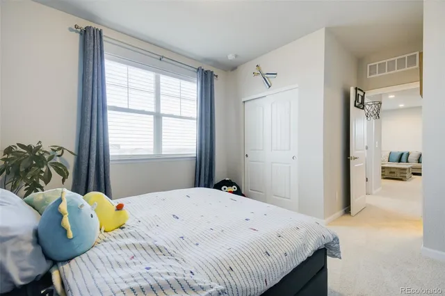 a large bed sitting in a bedroom next to a window
