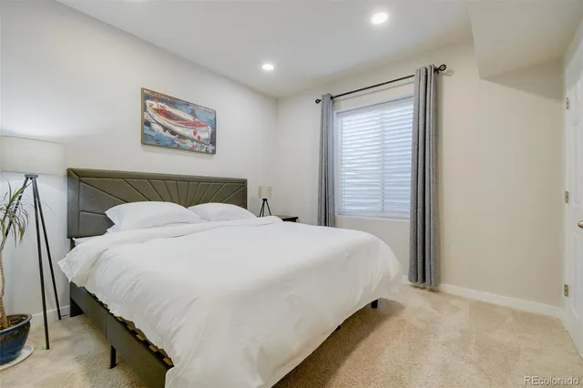a bathroom with a granite countertop sink a large mirror and a bathtub