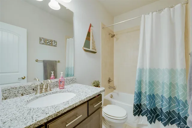 a bathroom with a sink a mirror and shower